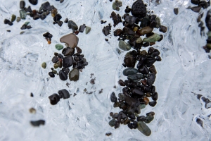 Close-up of Ice with Volcanic Sand and Pebbles